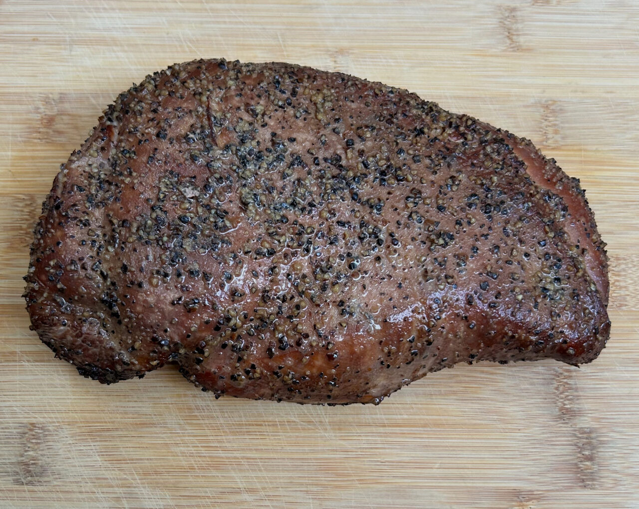 Juicy smoked Texas-Style Turkey Breast on the cutting board.