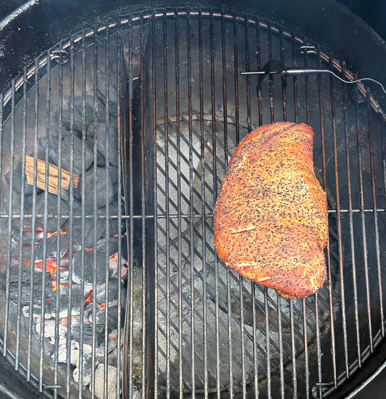 Smoked Texas-Style Turkey breast cooking on the grill.