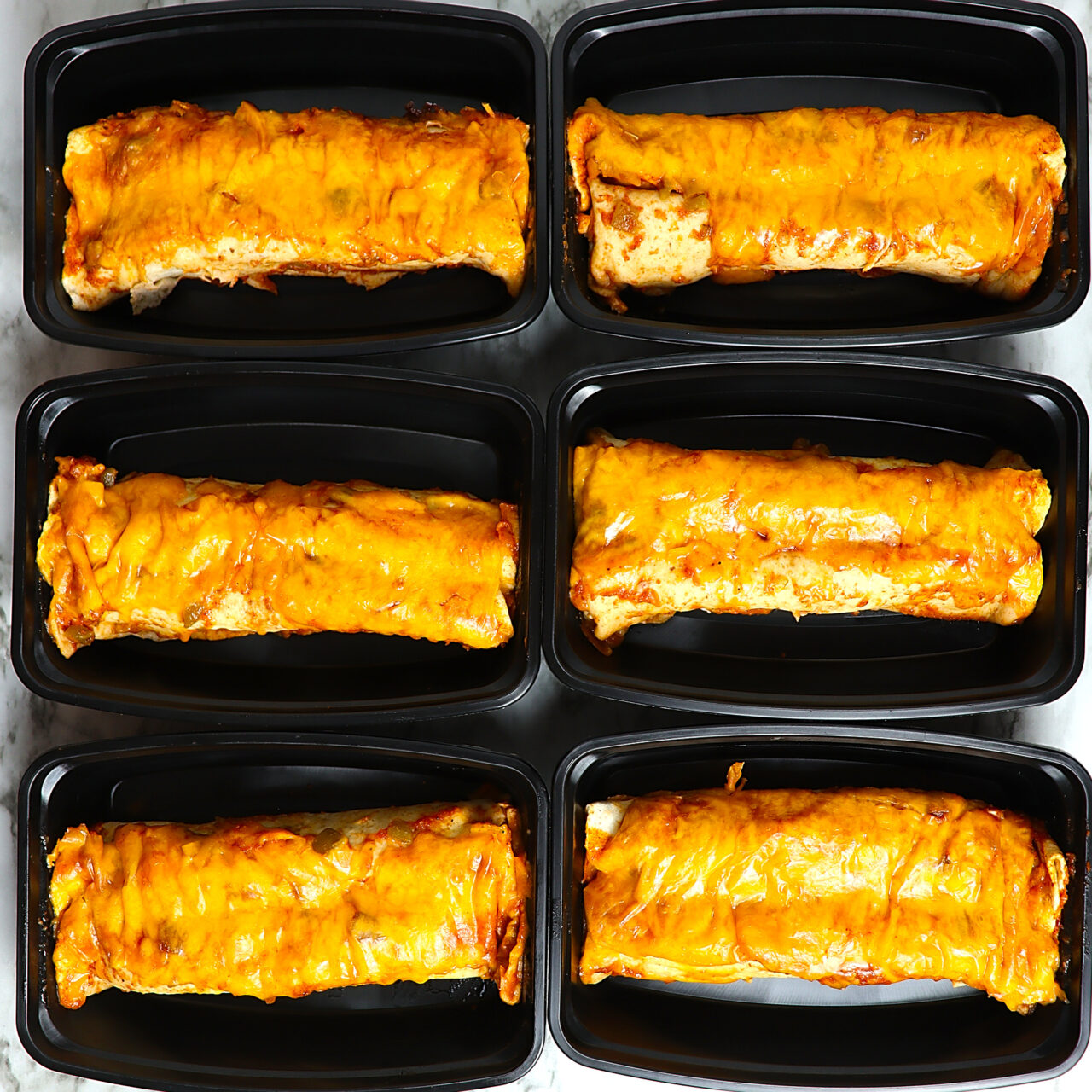 Chicken enchilada meal prep portioned into individual containers.