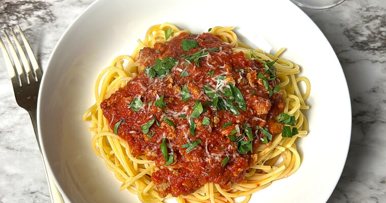 A bowl of spaghetti with homemade marinara sauce.