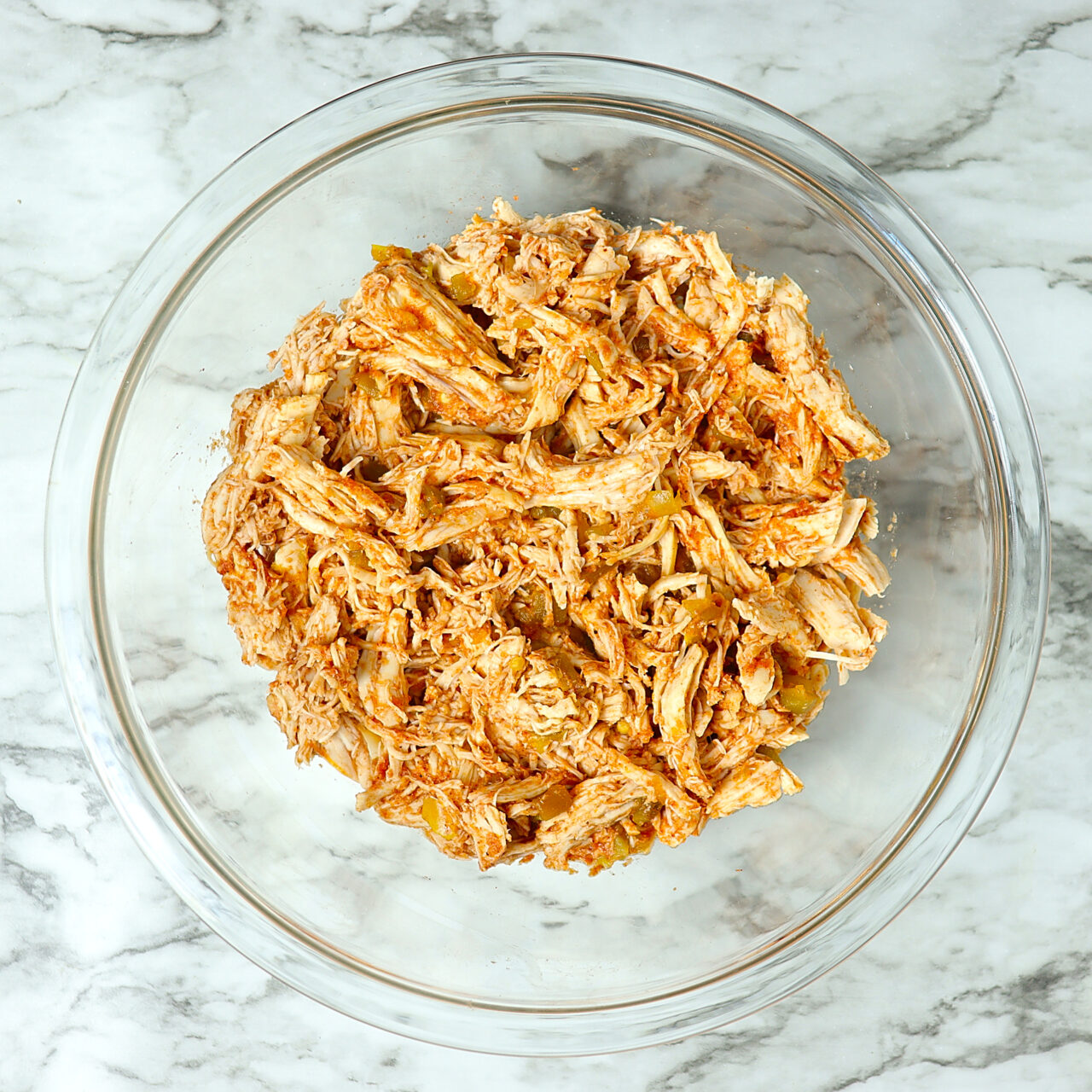 Shredded chicken mixed with homemade enchilada sauce.