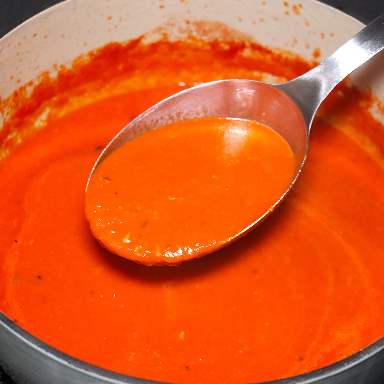 A tantalizing glimpse of the finished pot, brimming with luscious homemade San Marzano tomato soup, ready to delight the senses with its rich flavors and comforting warmth.