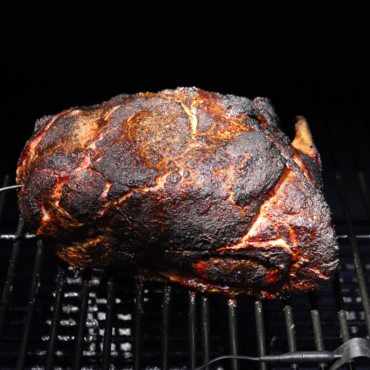 Cooked pork butt showcasing a mouthwatering bark, a testament to the perfect blend of smoky flavors and caramelized crust achieved through meticulous smoking.