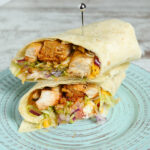 Grilled buffalo chicken wrap with tender chicken, fresh vegetables, and zesty sauce, served in a soft tortilla