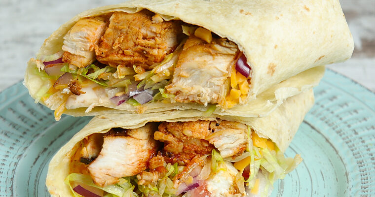 Grilled buffalo chicken wrap with tender chicken, fresh vegetables, and zesty sauce, served in a soft tortilla