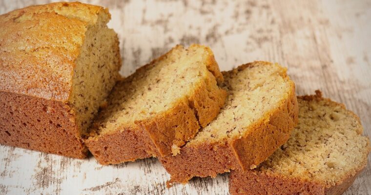 A loaf of warm moist, warm, sweet banana bread sliced.